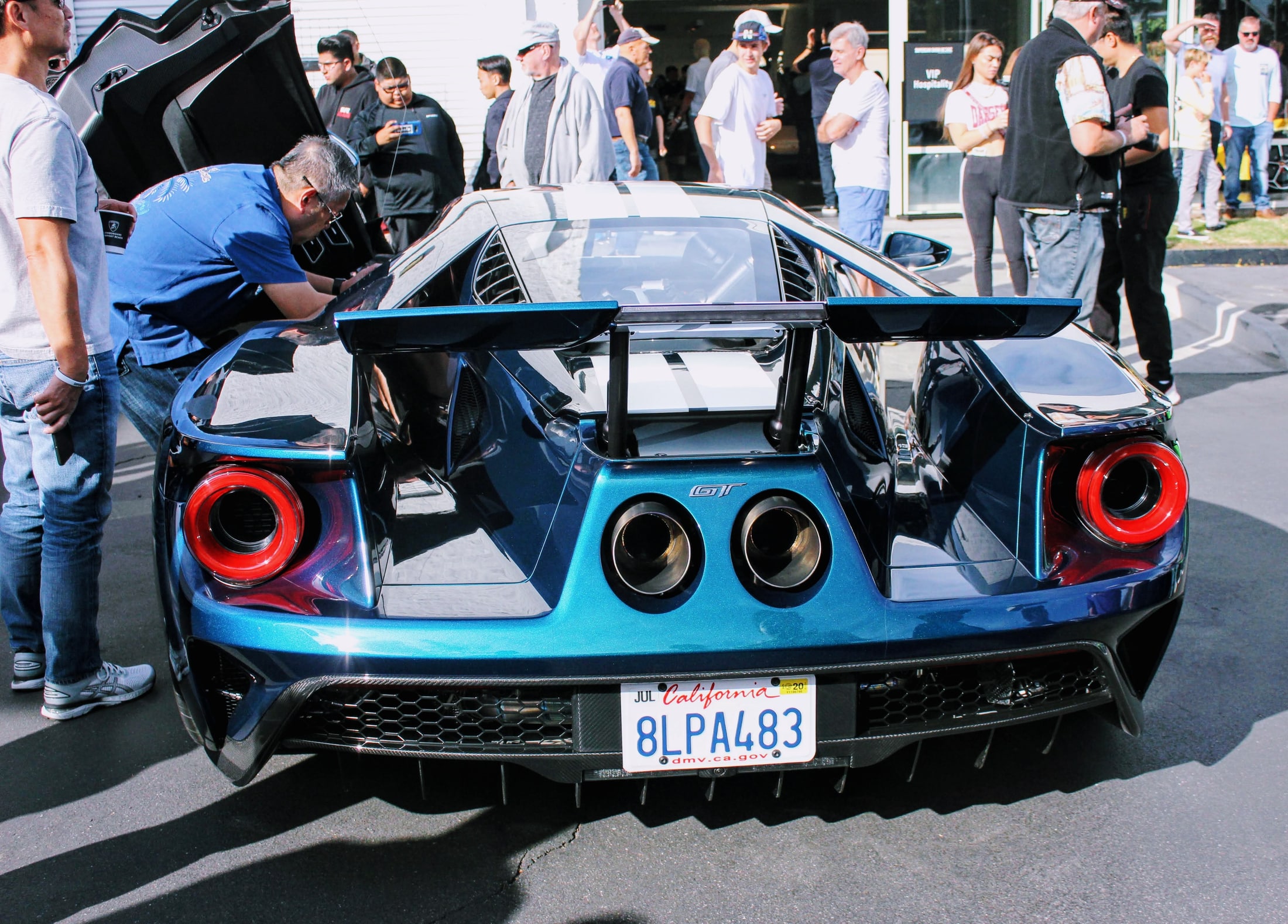 Centered rear view of the Mystichrome Ford GT with its active wing raised